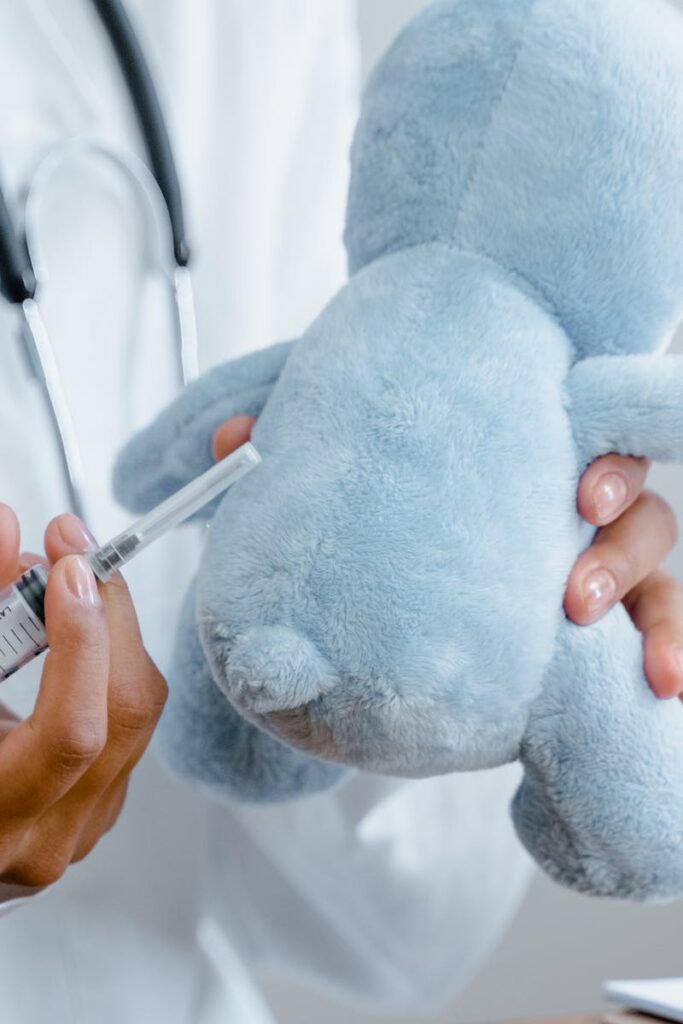 pexels-photo-8376311-8376311-1 Close-up of a doctor using a syringe on a plush toy for educational purposes.
